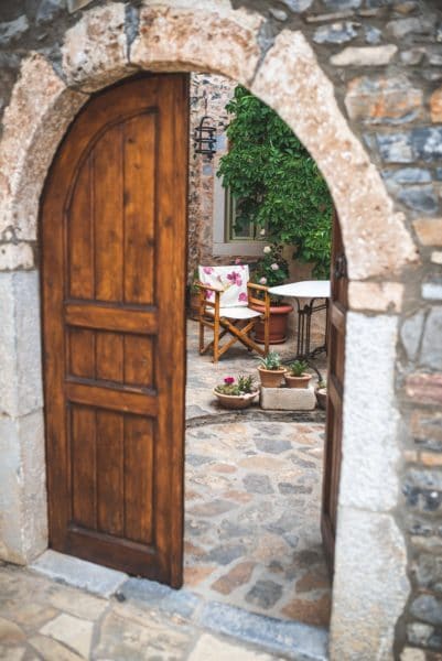 Brown Wooden Door Opened To Courtyard